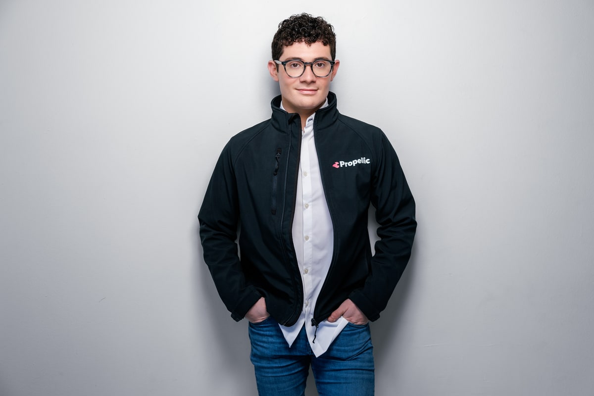 Studio portrait, light backdrop. Brennen Bliss.