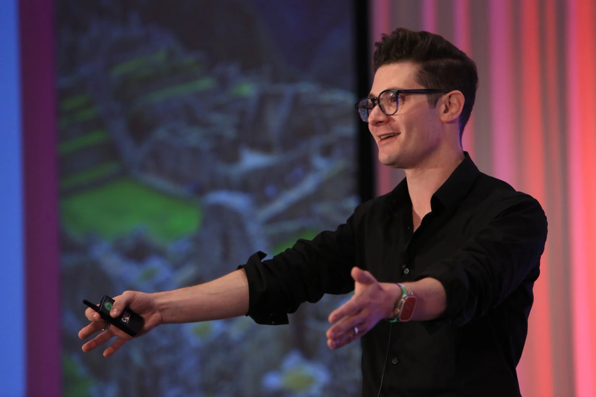 Presenting on stage. Brennen Bliss.